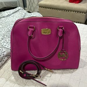 never used with long strap bag. More of a purple pink than true pink bag.